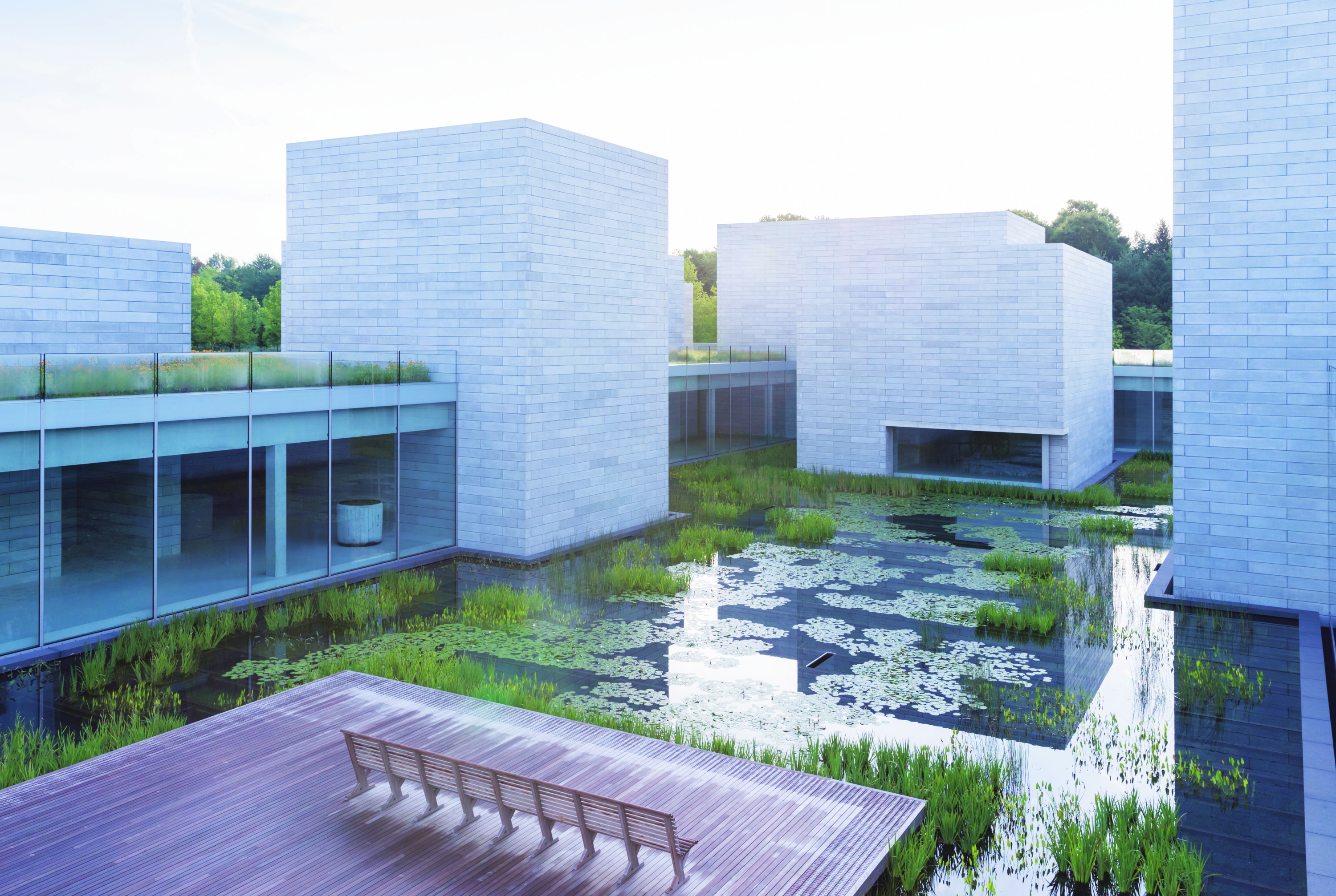 De Pavilions, de uitbreiding van Glenstone, bestaat uit onderling verbonden galeries, gegroepeerd rond een bassin, gelegen op een zacht glooiende heuvel. – © Glenstone, Iwan Baan