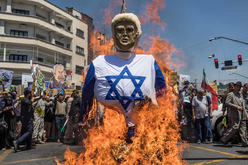 Demonstranten in Teheran verbranden een portret van Donald Trump. – © HH