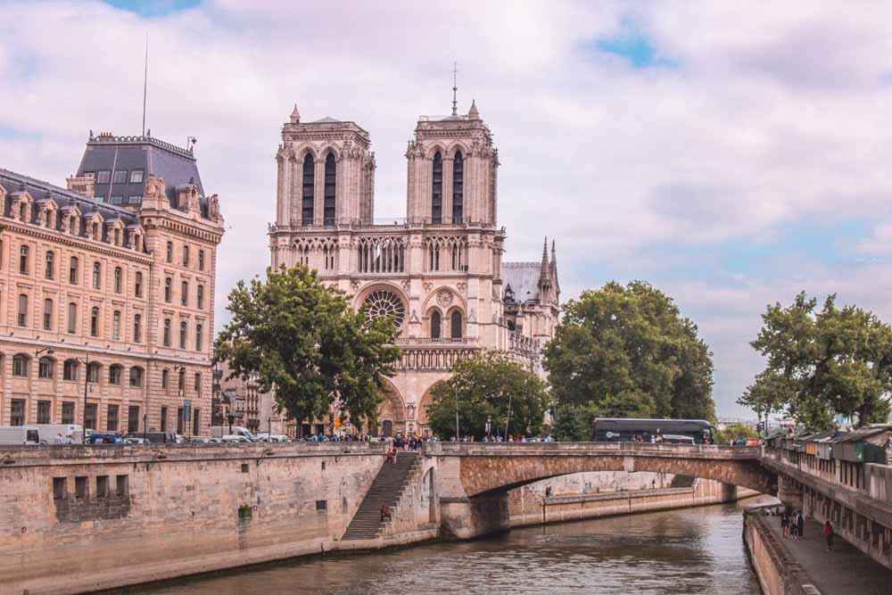 Boven: De Notre-Dame in Parijs. © Hannah Reding / Unsplash Onder: De overblijfselen van de Kalb Lose-kerk in Syrië met twee torens aan de voorzijde. Deze vroegchristelijke kerk vormde de inspiratie voor de Notre-Dame. © Bertramz / Wikipedia