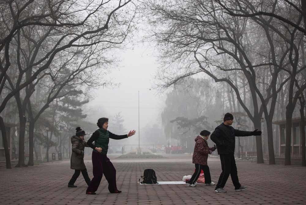 Tai Chi is een van de populairste activiteiten in het park. – © Kevin Frayer / Getty