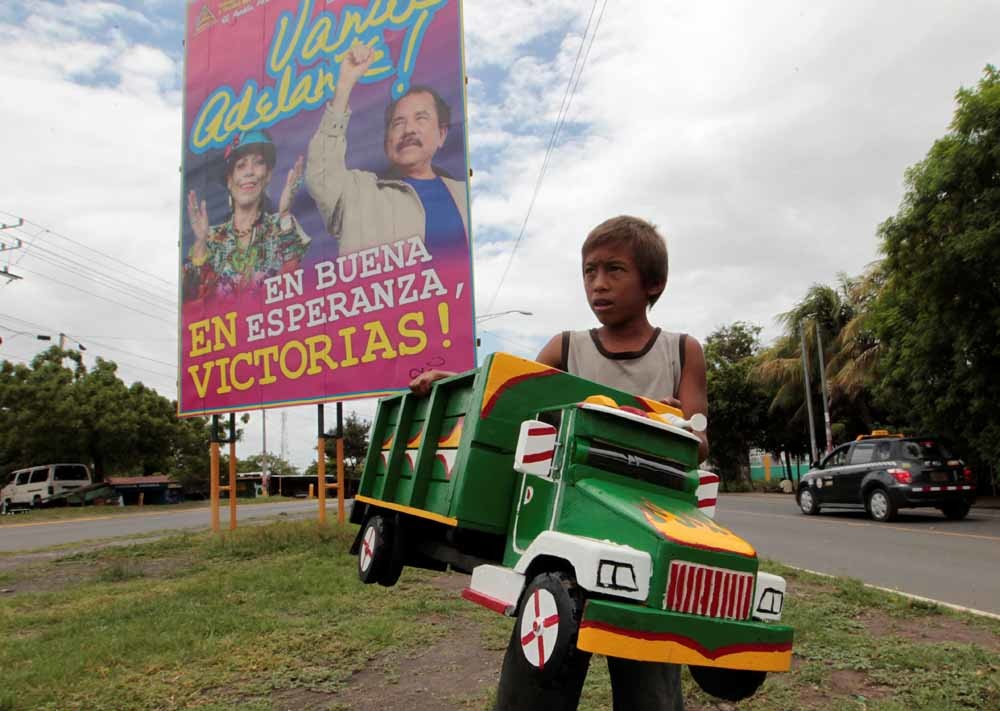 Daniel Ortega en zijn ‘running vrouw’ Rosario Murillo op een verkiezingsposter in Tipitapa, Nicaragua. – © Oswaldo Rivas / Reuters
